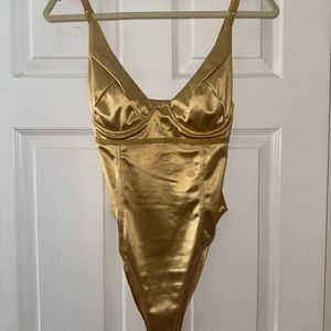 Shiny metallic gold body suit